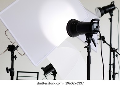 Photo or video studio with white soft screen and light equipments for shooting.