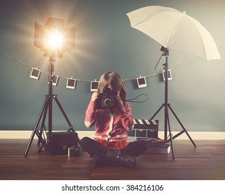 A Photo Of A Vintage Child Taking A Picture With An Old Camera In A Studio With Lights And Film For A Creativity Or Vision Concept.