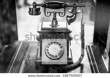 A photo of vintage landline telephone in black and white is displayed at a community restaurant. This believed to be used in the 60s to 80s in Cambodia. 