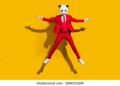 Photo Of Wacky Panda Guy Jump Have Fun Wear Mask Red Tuxedo Shoes Isolated On Yellow Color Background