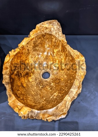 Photo of a wastafel made of fossilized rock. Vintage wastafel, unix wastafel
