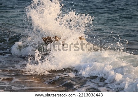 Similar – waves and splashes of sea surf and stones on the seashore in Egypt Dahab South Sinai