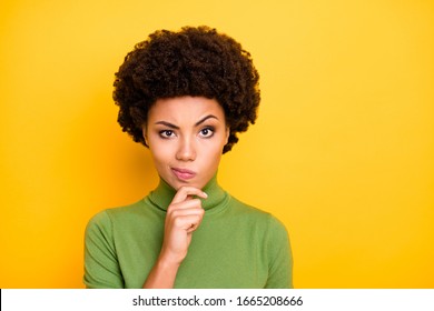 Photo of wavy brown haired interested woman grimacing touching chin with curiousity on face isolated vivid color background - Powered by Shutterstock