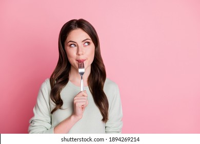Photo of wavy hairdo lady lick fork mouth look empty space isolated on pastel pink color background