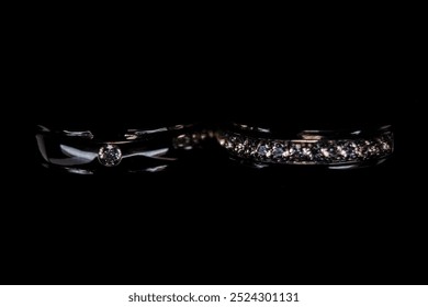 photo of wedding rings from above on a black background - Powered by Shutterstock