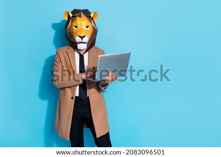 Photo of weird incognito freak guy manager lion mask use device netbook search carnival news isolated over blue color background