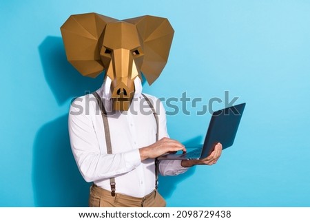 Photo of weird strange man wear elephant working modern gadget empty space isolated blue color background