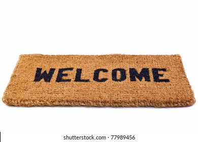 Photo of a welcome door mat isolated on a white background.
