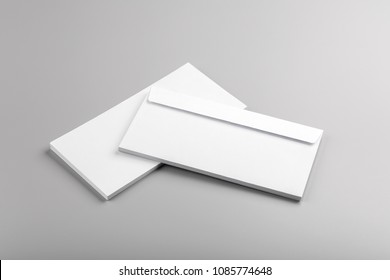 Photo of white envelope isolated on gray background. Template for branding identity. For graphic designers presentations and portfolios. Envelopes isolated on gray. White envelope mock-up. 
