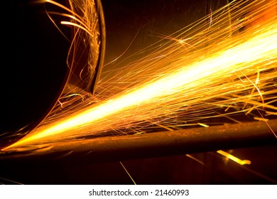 Photo of white hot sparks at grinding steel material