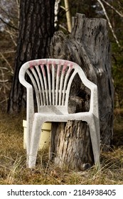 Photo Of A White Plastic Chair Outdoors In Nature