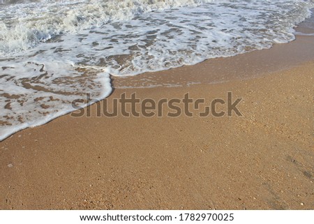 photo of white sea foam and sand