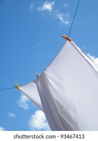 Photo Of A White Sheet Hanging On A Clothes Line