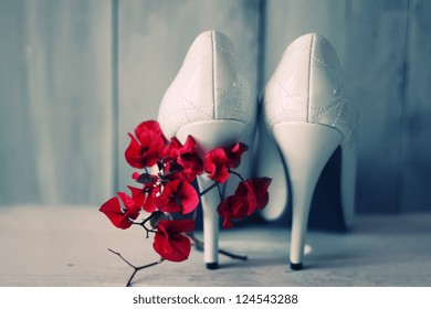 Photo of white shoes and flowers