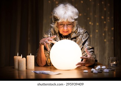 Photo of woman foretelling future from crystal ball