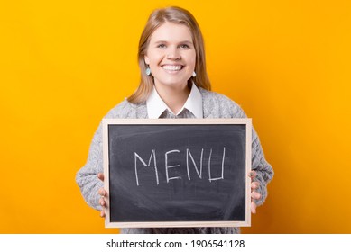 Photo of a woman holding a blackboard with the word menu written on it . - Powered by Shutterstock