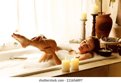 Photo Of A Woman Relaxed At Luxury Spa Salon, Picture Of Young Beautiful Lady Taking Bath At Home, Image Of Pretty Female Bathing With Soap Foam And Candles In Hotel Room, Cute Girl Relax In Jacuzzi