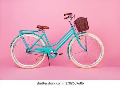 Photo of woman retro vintage bicycle used for town transportation with brown basked isolated over pink color background