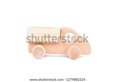 Photo of a wooden car dump truck made of beech on a white isolated background 