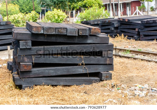 photo of\
wooden sleeper, pile up beside\
railroad