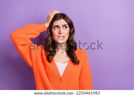Photo of worried nervous lady wear orange clothes arm head look empty space thinking how avoid problems isolated on purple color background