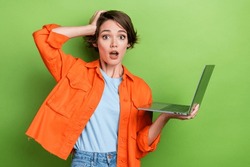 Photo Of Worried Nervous Stressed Depressed Lady Wear Orange Stylish Clothes Hold Broken New Device Isolated On Green Color Background