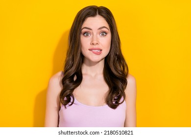 Photo Of Worried Young Lady Biting Lip Look Camera Isolated On Bright Yellow Color Background