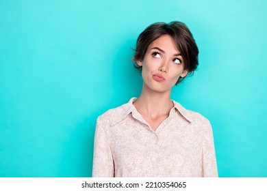 Photo of young adorable perfect gorgeous funny girl grimace pouted lips minded looking empty space interested new ad isolated on cyan color background - Shutterstock ID 2210354065