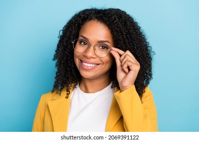 Photo of young african cheerful woman happy positive smile hand touch eyeglasses isolated over blue color background