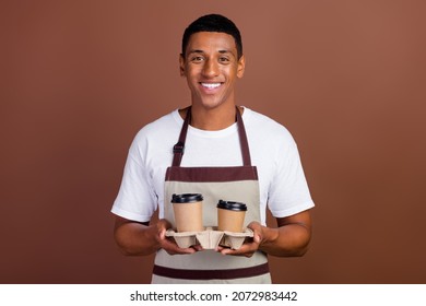 Photo of young african man cafe holder cup tea delivery caffeine americano hold isolated over brown color background