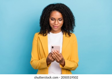 Photo of young african woman happy positive smile look read browse internet smartphone isolated over blue color background - Powered by Shutterstock