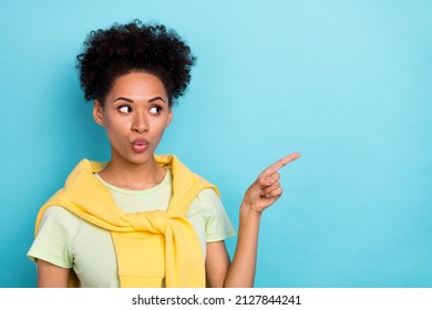 Photo of young african woman impressed indicate finger empty space direct ads isolated over blue color background - Shutterstock ID 2127844241