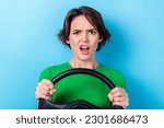 Photo of young angry grimace girl drive steering wheel her new kia rio bad safety while traveling airbag not work isolated on cyan color background