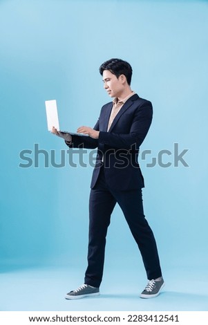 Photo of young Asian businessman on background