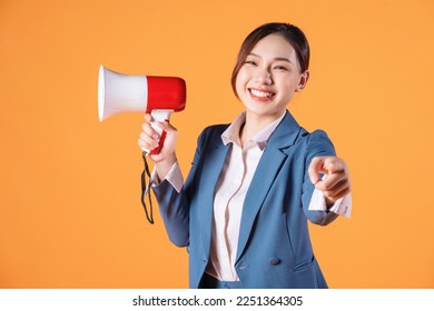 Photo of young Asian businesswoman holding megaphone on background - Powered by Shutterstock