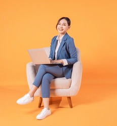 Photo Of Young Asian Businesswoman Sitting On Armchair