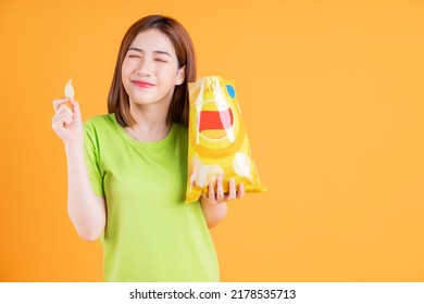 Photo Of Young Asian Girl Eating Snack On Background