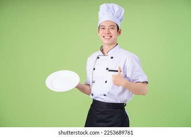 Photo of young Asian male chef on background - Powered by Shutterstock