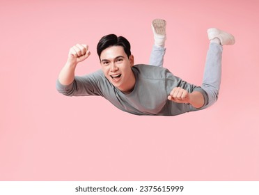 Photo of young Asian man flying on background