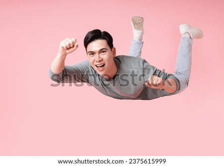 Photo of young Asian man flying on background