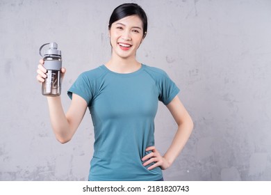 Photo Of Young Asian Woman Holding Water Bottle