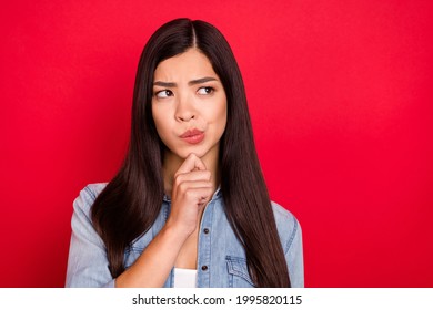 Photo Of Young Attractive Asian Girl Think Hmm Deep Minded Idea Hand Touch Chin Look Empty Space Isolated Over Red Color Background