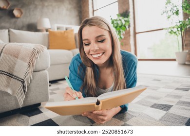 Photo of young attractive blonde hair domestic lady wearing blue casual shirt indoors loft apartment living room write notes in copybook - Powered by Shutterstock