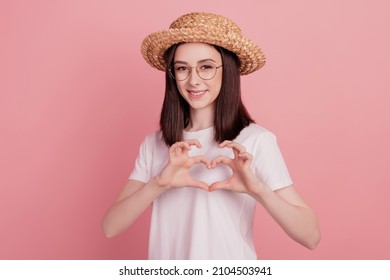 Photo of young attractive girl happy positive smile sunhat vacation show fingers heart symbol isolated over pink color background - Powered by Shutterstock