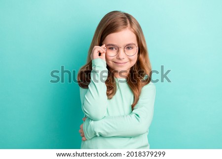 Photo of young attractive girl happy positive smile hand touch eyeglasses isolated over teal color background