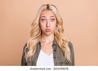 Photo Of Young Attractive Girl Pouted Cheeks Hold Breath Humor Joke Dumb Isolated Over Beige Color Background