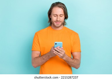 Photo Of Young Attractive Handsome Student Man Using Phone Addicted Watching Youtube Online Isolated On Blue Color Background