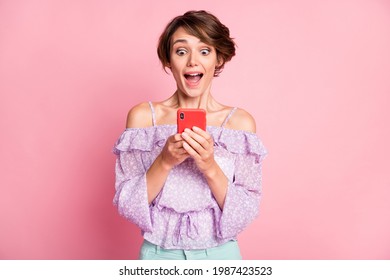 Photo Of Young Attractive Lovely Excited Happy Amazed Girl See Many Likes In Phone Isolated On Pink Color Background