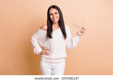 Photo of young attractive woman happy positive smile confident hold glasses isolated over beige color background