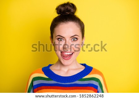Photo of young attractive woman happy positive smile excited amazed tongue-out tasty lick teeth isolated over yellow color background
